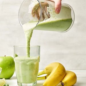fresh-green-smoothie-pouring-into-glass-4ALM7TA.jpg